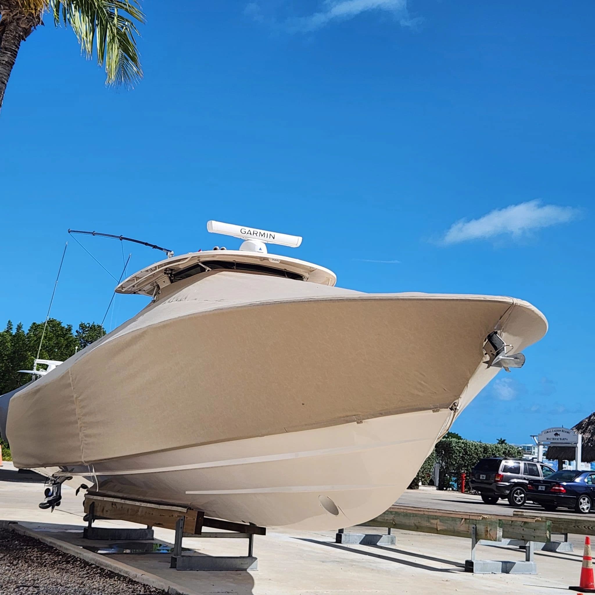 Tan full cover fitted bow-to-stern on a large center console at the marina