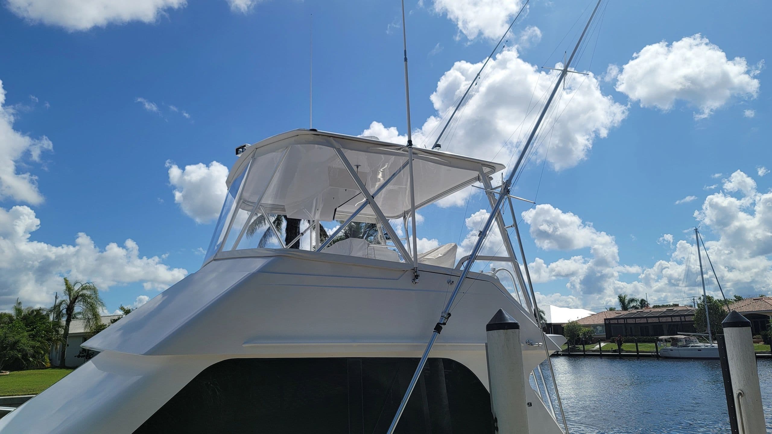 Flybridge enclosure with clear panels and white canvas on a sportfish