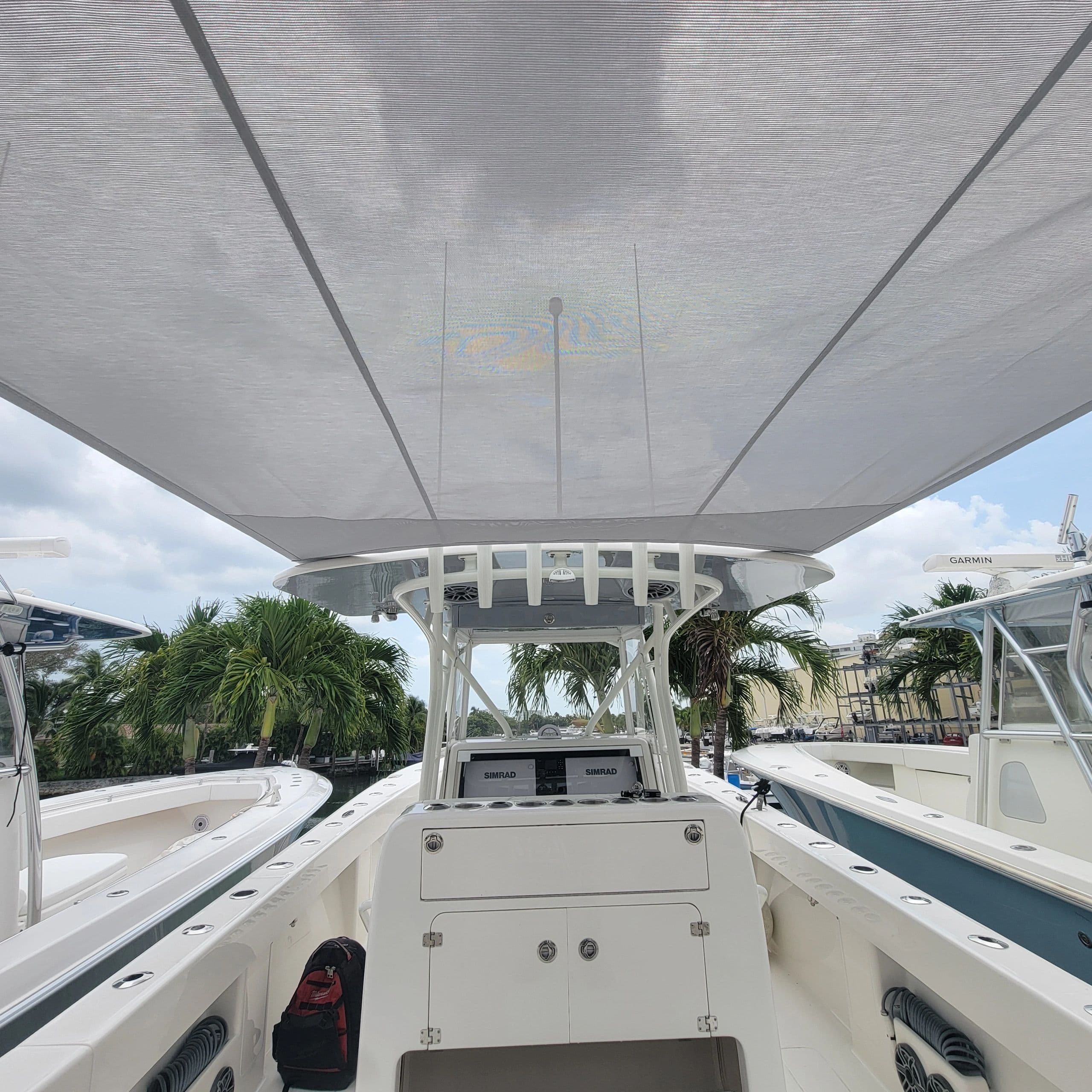 Custom mesh sun shade rigged off a boat's T-top — Canvas Craft's own work
