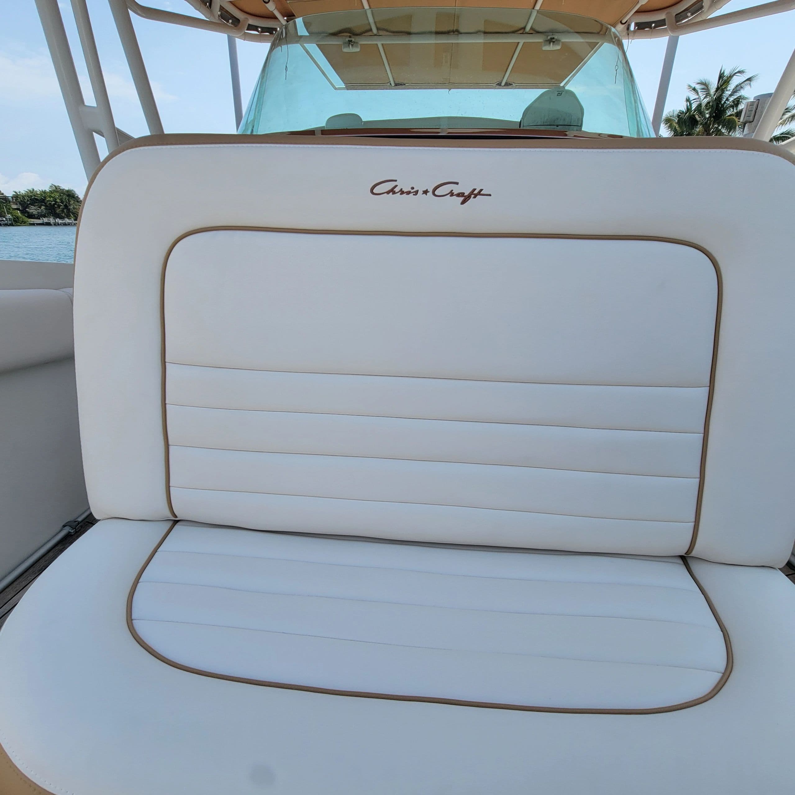 Custom white bench cushions with piped trim on a center console — Canvas Craft's own work